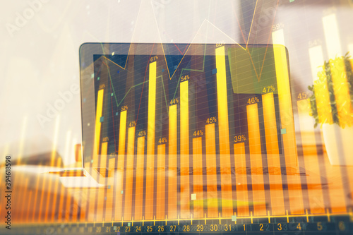 Stock market chart hologram drawn on personal computer background. Double exposure. Concept of investment.