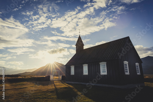 Budakirkja, black church in Iceland in sunset photo