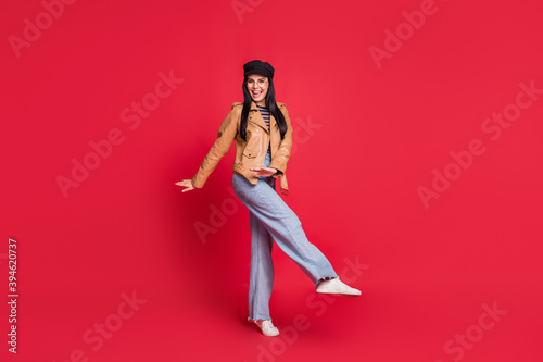 Full body photo of cheerful pretty lady dancing partying wear black hat isolated on red color background