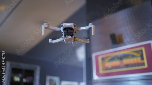 A small drone weighing 249 grams close-up on a blurred background at home, the drone camera shoots in 4 fps. photo
