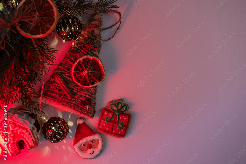 Christmas holiday neon color background with fir branches, toys garland and decorations. Xmas and Happy New Year theme. Flat lay, top view, space for text