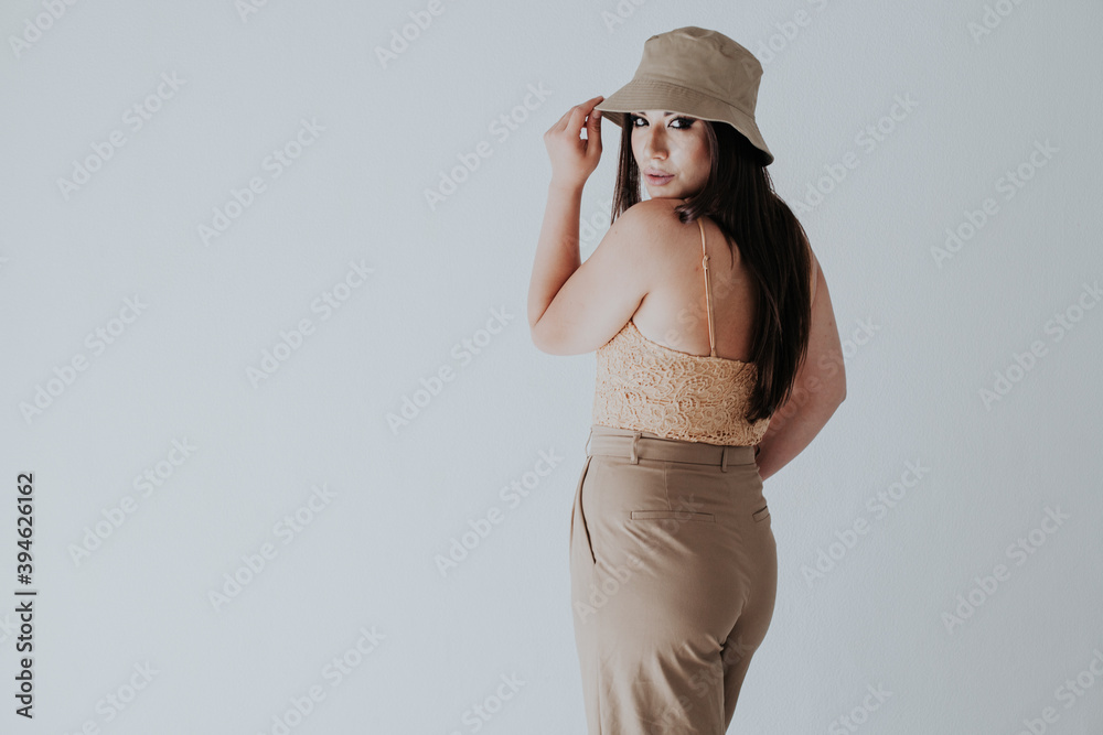 Beautiful oriental fashionable brunette woman in beige clothes Beautiful oriental fashionable brunette woman in beige clothes