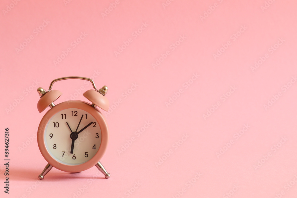 Pink alarm clock on pink background with copy space for text. Morning concept Pink alarm clock on pink background with copy space for text. Morning concept
