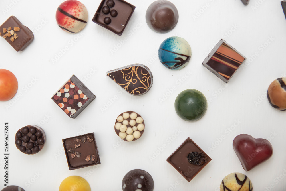 lot of variety chocolate pralines, top view of various chocolate pralines isolated on white background lot of variety chocolate pralines, top view of various chocolate pralines isolated on white background