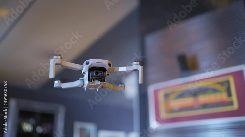 A small drone weighing 249 grams close-up on a blurred background at home, the drone camera shoots in 4 K photo