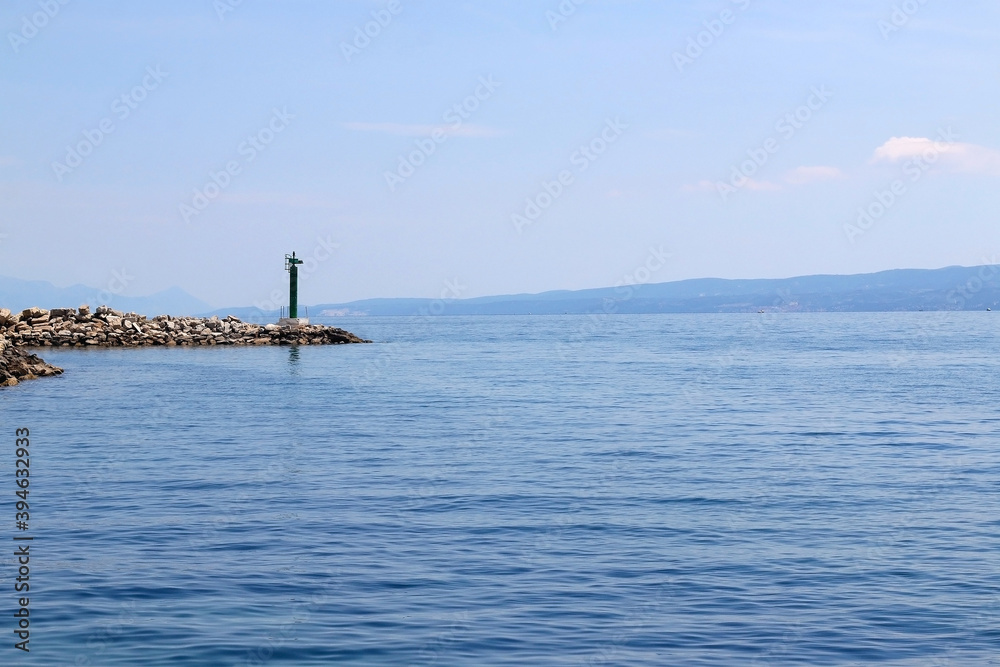 Clear sea and small lighthouse on the beach in Split, Croatia.