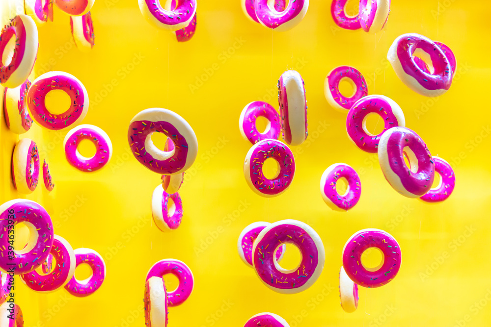 Fototapeta premium sweet donuts floating on yellow background