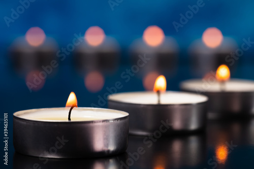 Small glowing candles on a beautiful background.