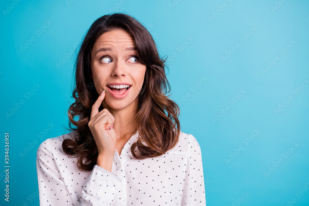 Portrait of impressed nice brunette girl hand chin look empty space wear shirt isolated on teal color background Portrait of impressed nice brunette girl hand chin look empty space wear shirt isolated on teal color background