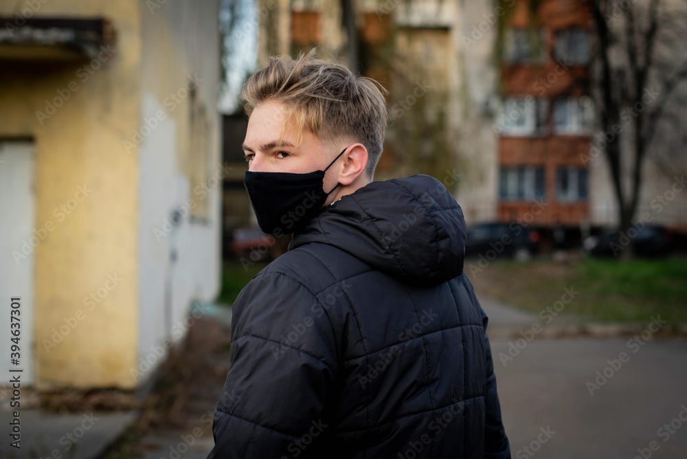 Cute teenage boy in a surgical bandage. Coronavirus, illness, infection, quarantine, medical mask, COVID-19. Boy in a medical mask. Quarantine and protection virus, flu, epidemic COVID-19.