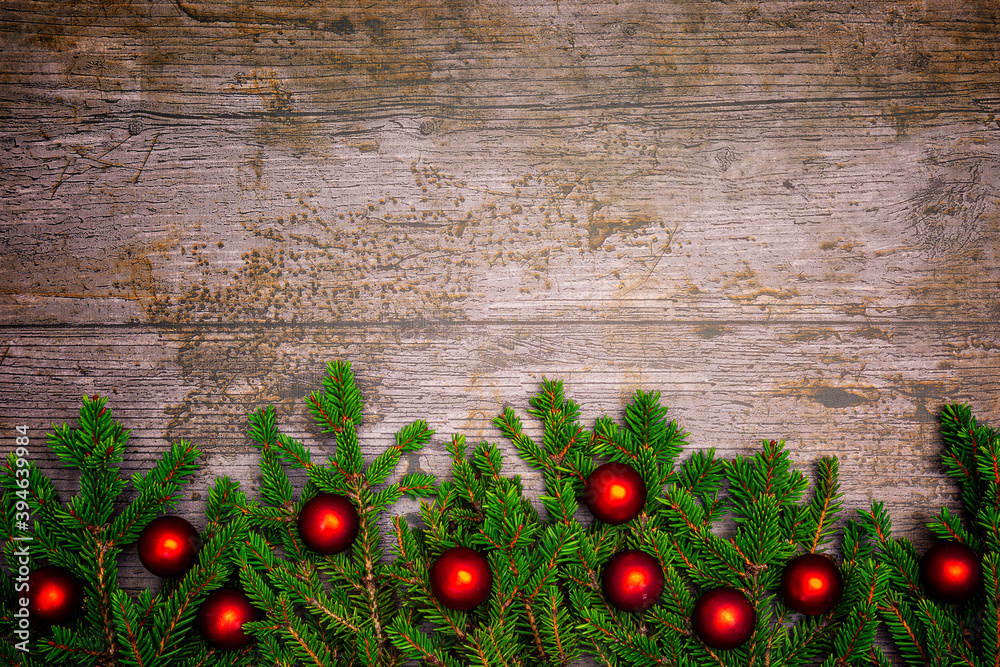 Christmas or New Year decoration background with pine twigs and red baubles on a wooden table with copy space. Christmas or New Year decoration background with pine twigs and red baubles on a wooden table with copy space.