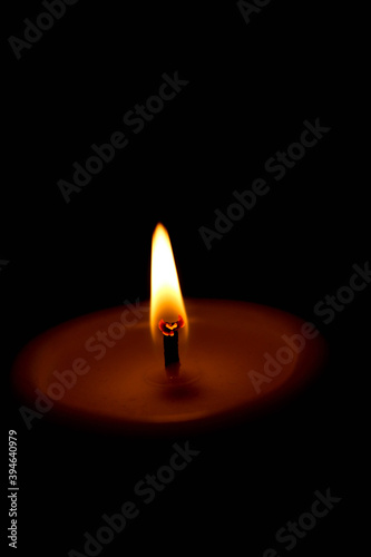 vertical wallpaper background burning candle in the dark close up