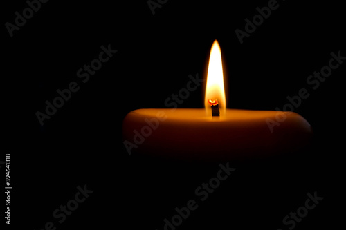 burning candle on black background in the dark beautiful romantic wallpaper