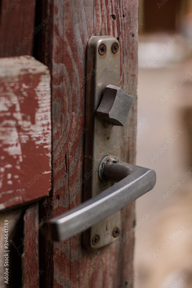 old wooden red door with a metal handle old wooden red door with a metal handle