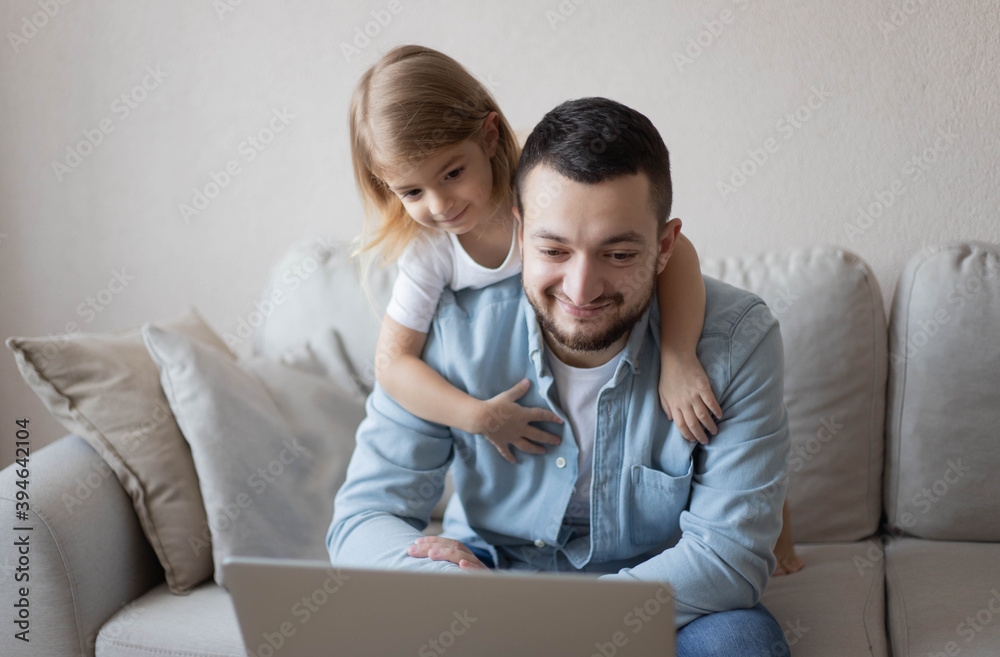 Work from home. Man working on laptop with child playing around. businessman watching child and spending time with kid. Freelance concept. Happy modern family. Work from home. Man working on laptop with child playing around. businessman watching child and spending time with kid. Freelance concept. Happy modern family.