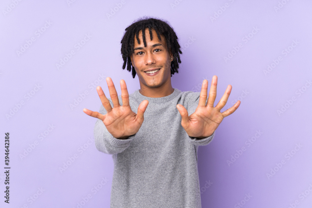 Young african american man isolated on purple background counting ten with fingers Young african american man isolated on purple background counting ten with fingers