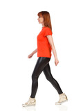 Cheerful Young Woman Is Walking And Looking Away