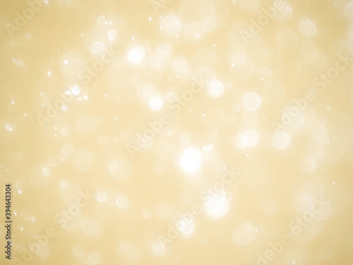Golden background with soft bokeh lights.