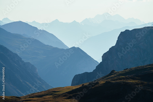 Awesome scenic view to great mountains in distance behind deep gorge. Wonderful mountain landscape with giant rockies and deep abyss. Highland scenery with huge cliff. Big rocks and precipice.