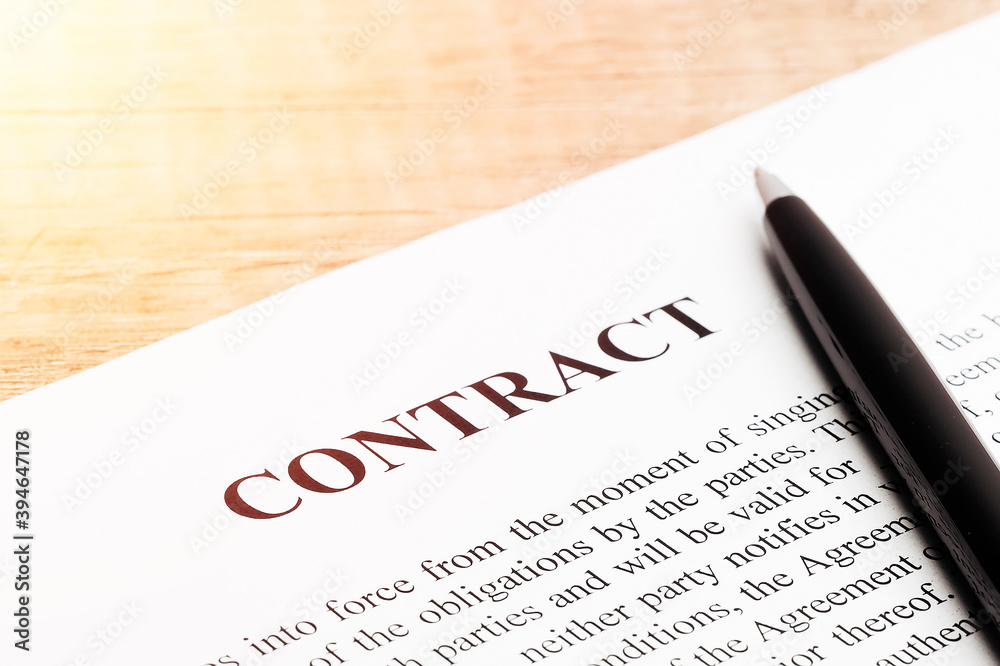 Legal contract signing - buy sell real estate contract. Close up. Legal contract signing - buy sell real estate contract. Close up.