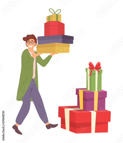 Smiling man with gift boxes in his hands near containers on the floor. Young handsome fashion shopper guy carrying presents on white background. Male character in store is prepairing for the holiday