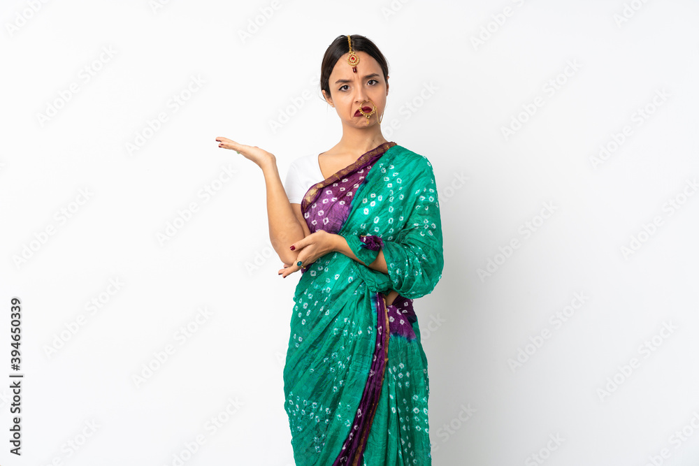 Young indian woman isolated on white background having doubts Young indian woman isolated on white background having doubts
