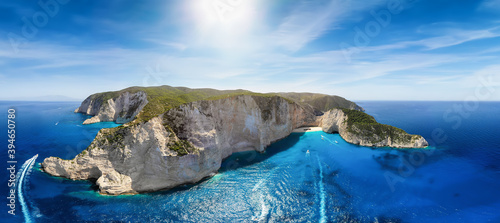 Beautiful panoramic aerial view to the famous Shipwreck Beach Navagio on Zakynthos island, Greece, with tourist boat traffic over the blue sea