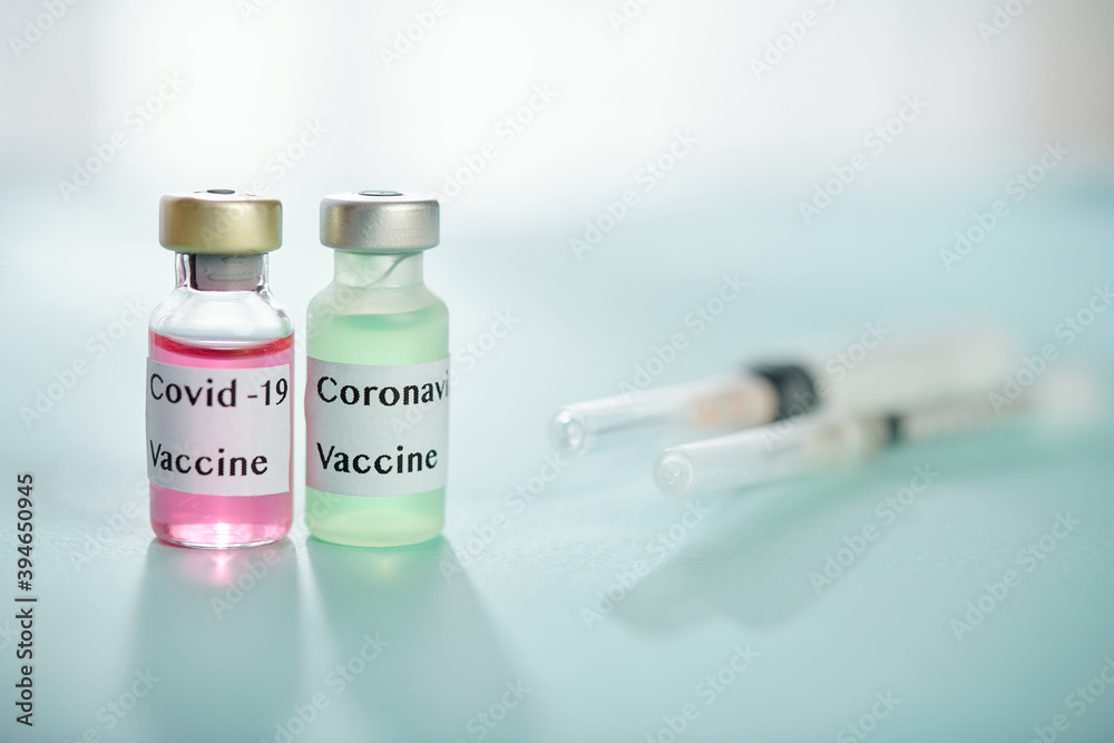 Two vials with different kinds of vaccine against coronavirus and syringes Two vials with different kinds of vaccine against coronavirus and syringes