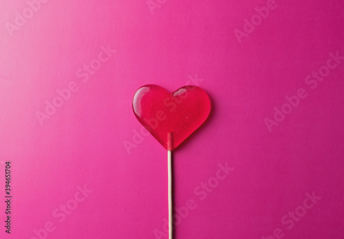 pink lollipop heart on pink background