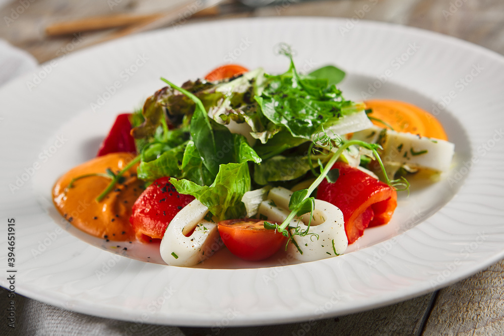 Roasted pepper salad with calamari and fresh greens