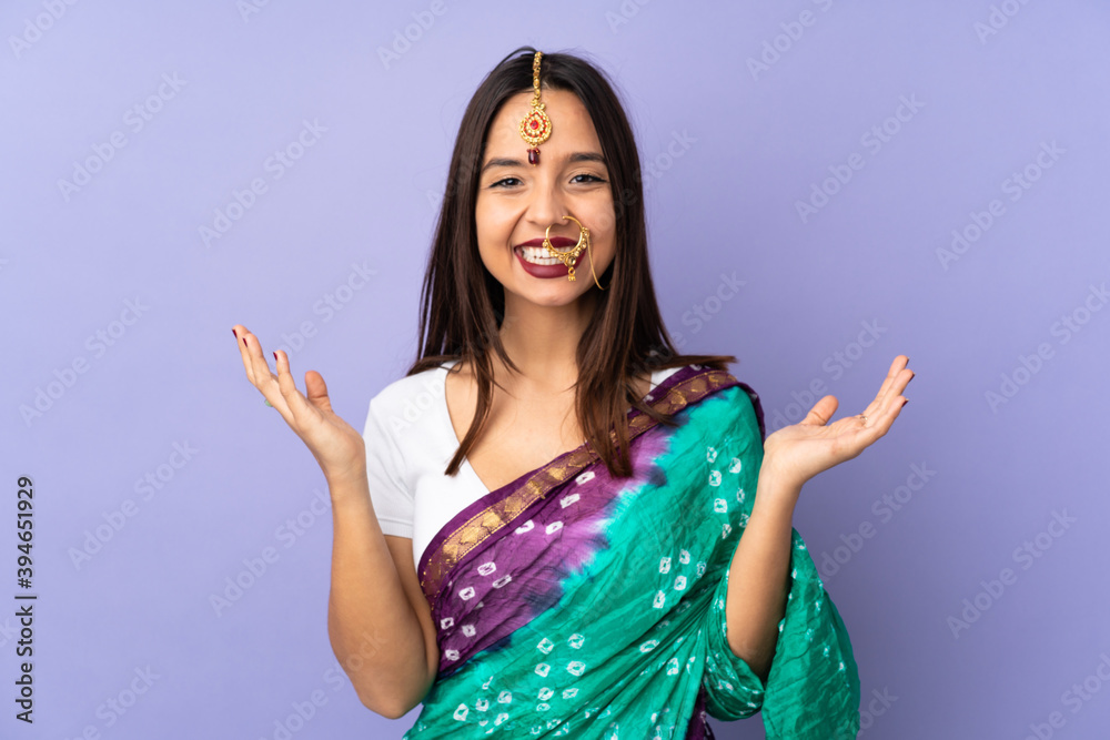 Young Indian woman isolated on purple background smiling a lot Young Indian woman isolated on purple background smiling a lot