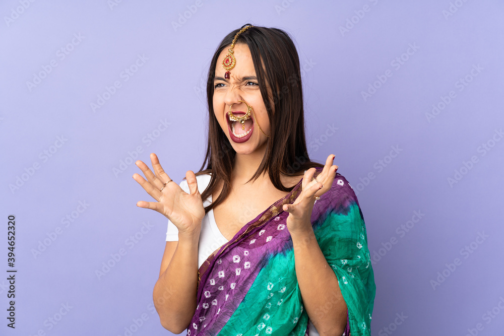 Young Indian woman isolated on purple background with surprise facial expression Young Indian woman isolated on purple background with surprise facial expression