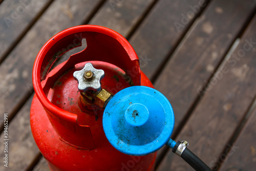 Old gas cylinder on the wooden floor. Selective focus. Closeup