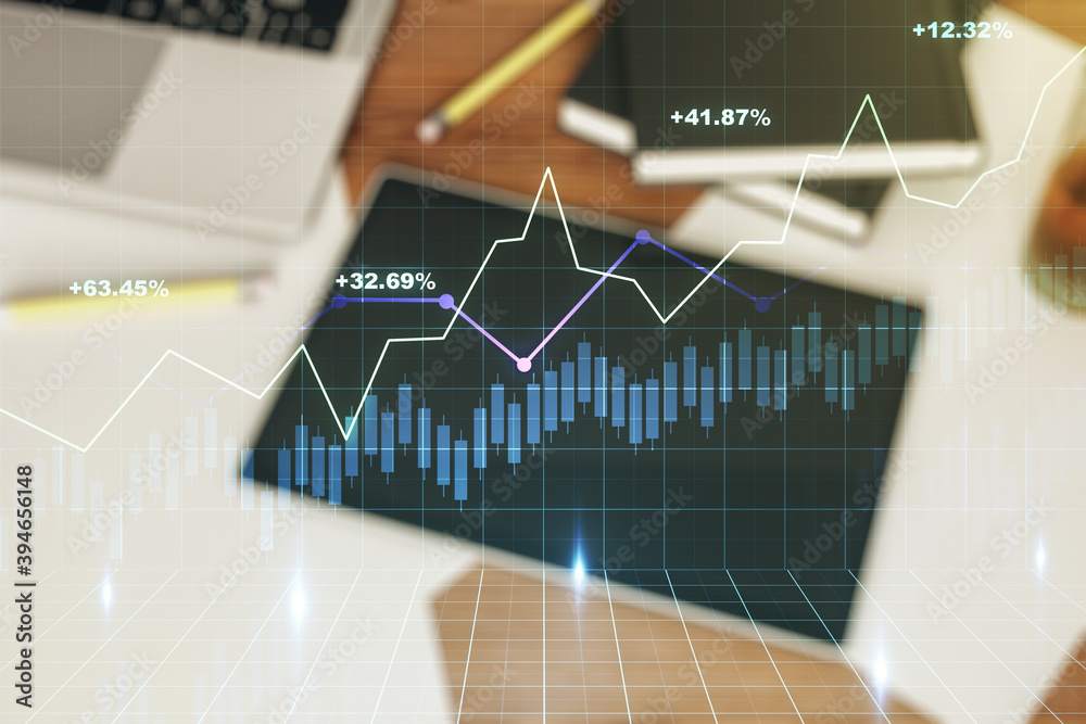 Abstract creative financial graph and modern digital tablet on background, top view, forex and investment concept. Multiexposure Abstract creative financial graph and modern digital tablet on background, top view, forex and investment concept. Multiexposure