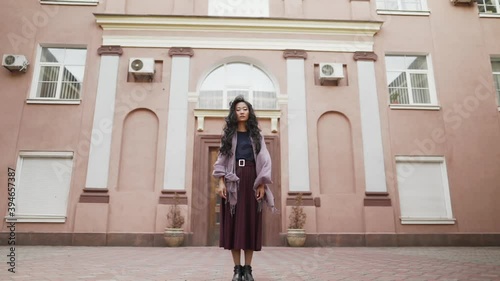 Wallpaper Mural Young pretty asian woman staying near big residential apartments looking to camera Torontodigital.ca