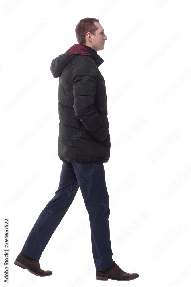 casual young man in autumn jacket striding forward. casual young man in autumn jacket striding forward.