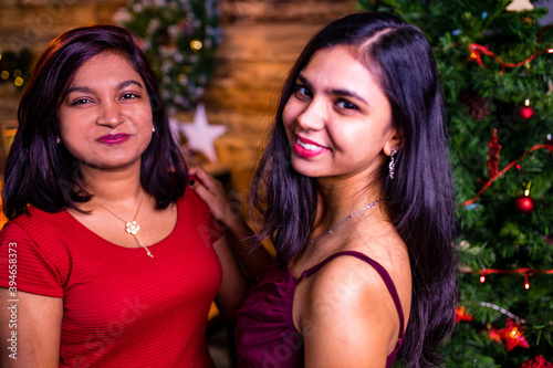 indian sisters fashion portrait of pretty young best friends celebrating Christmas party