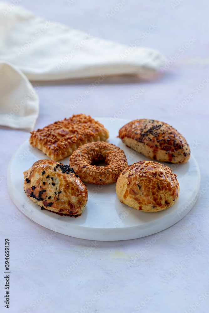 Salted pastries with cookies with sesames on serving plate Salted pastries with cookies with sesames on serving plate