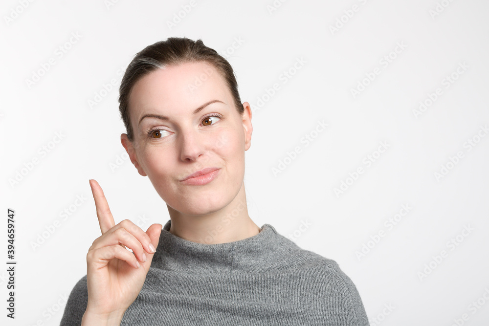 young woman rises her trigger finger and grimaces and like she guessed young woman rises her trigger finger and grimaces and like she guessed