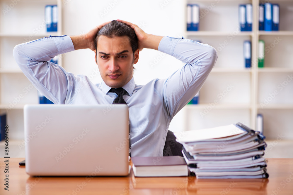 Young male employee working at workplace Young male employee working at workplace
