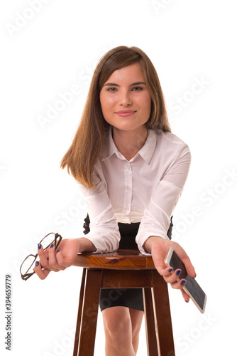 Girl in office clothes with a phone in her hands. photo