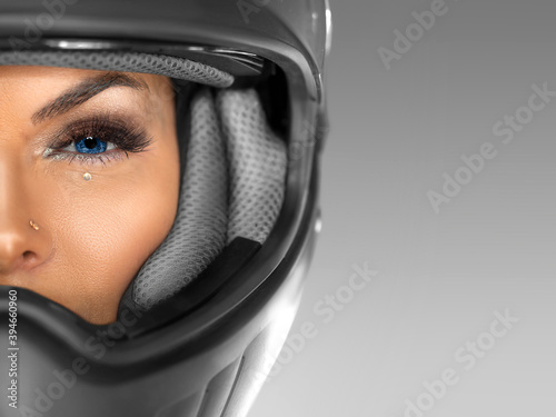 Close portrait of a woman in a motorcycle helmet. Half face. © Stavros