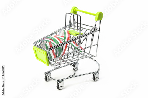 closeup on supermarket shopping cart isolated with a Italian tricolor ribbon