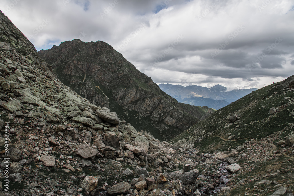 Rocky path between mountains, stones around. Summer. Russia, Kakaz, Arkhyz