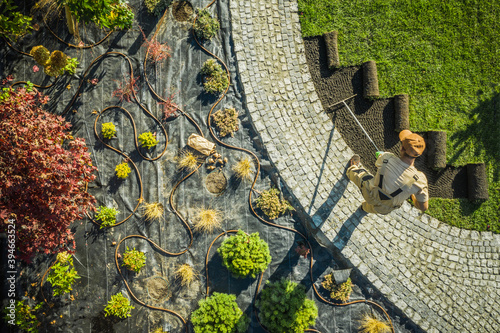 Leinwand Poster Landscape Specialist Finishing Newly Developed Garden