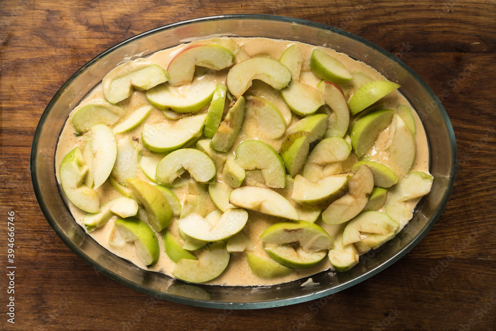 apple pie with cut apples sauce, close up photo on a wooden table apple pie with cut apples sauce, close up photo on a wooden table