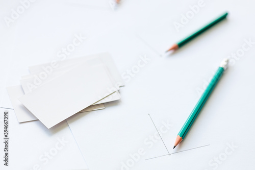 blank business cards and a white sheet of paper containing