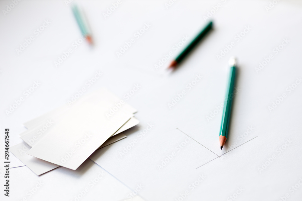 beginning drawing on a sheet of white paper and blank business cards beginning drawing on a sheet of white paper and blank business cards