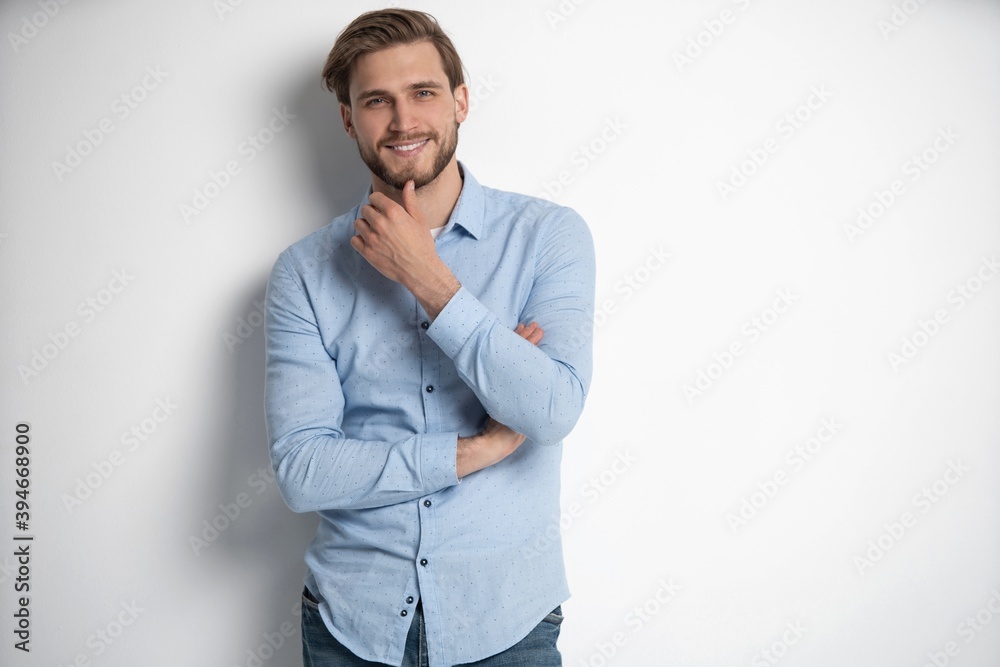 Portrait of a smart young man standing against white background. Portrait of a smart young man standing against white background.
