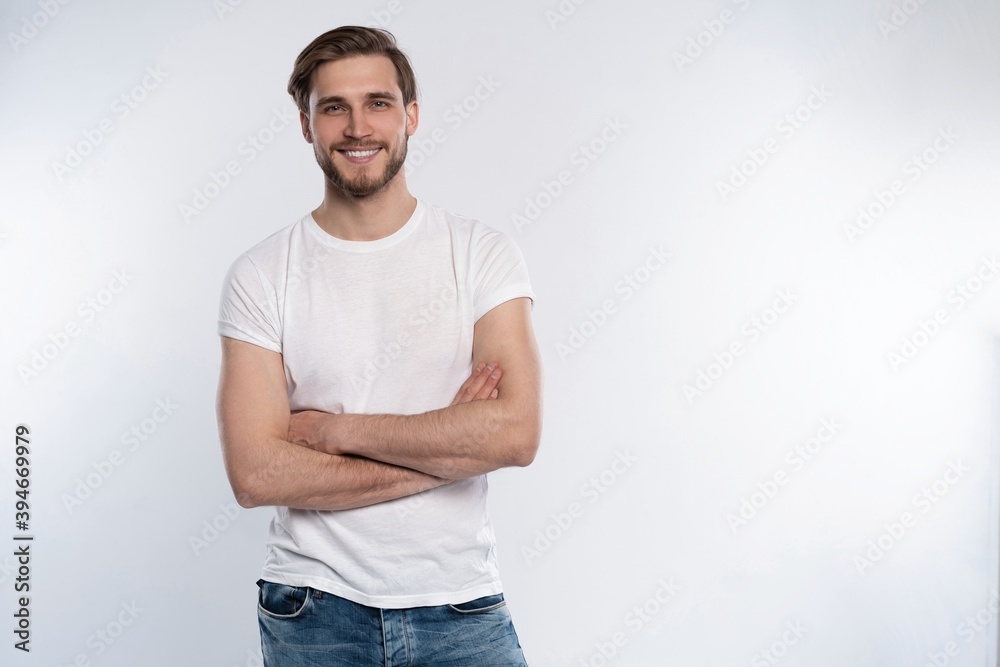 Portrait of a smart young man standing against white background.